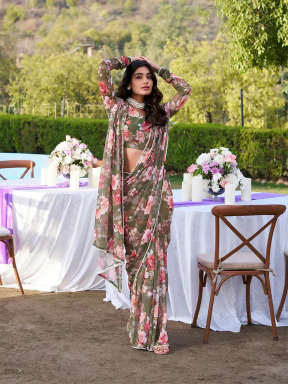 Woman in a floral outfit standing outdoors with tables and flowers in the background