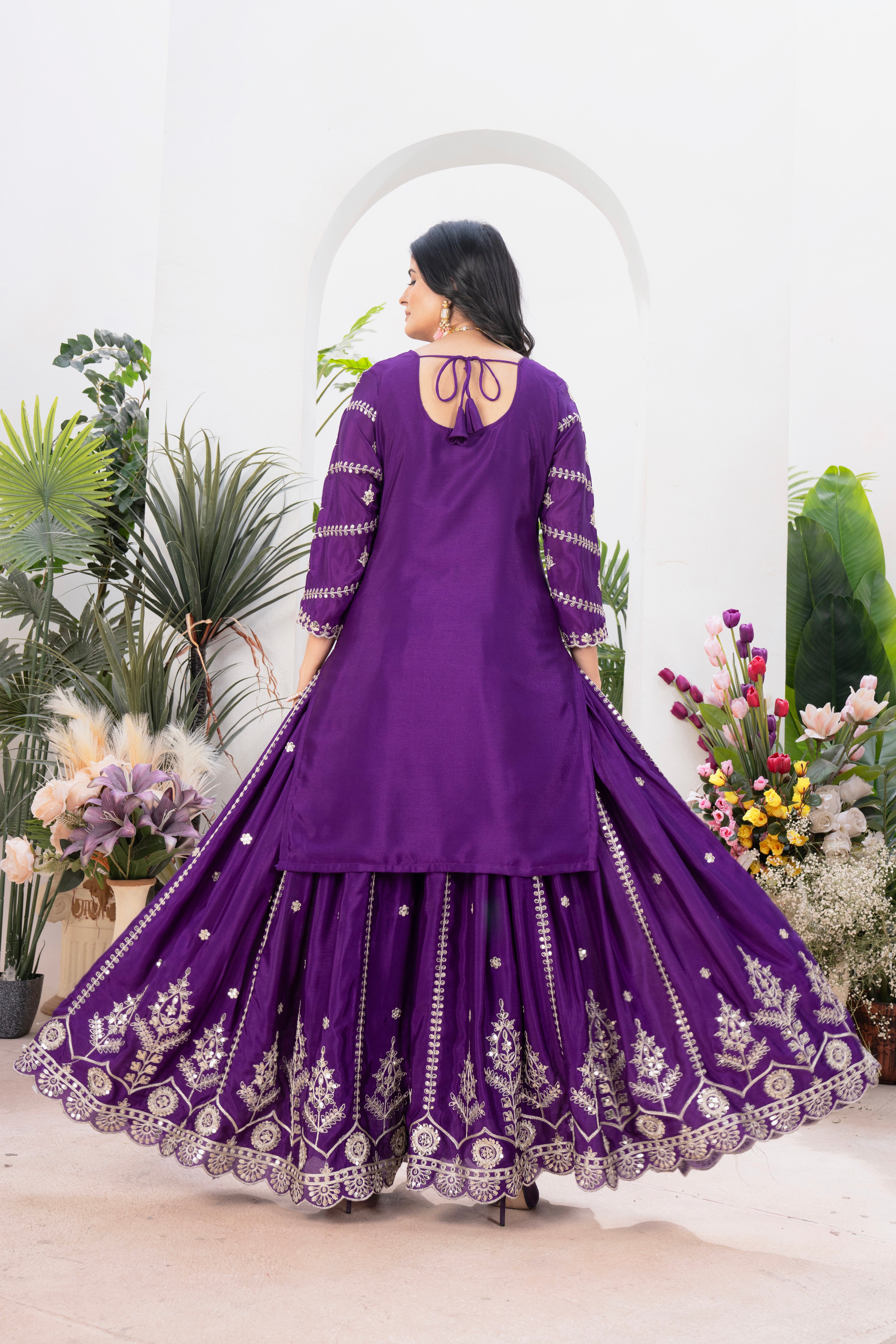 Embrace sophistication in this exquisite purple lehenga sharara suit, which combines classic design elements with modern flair.