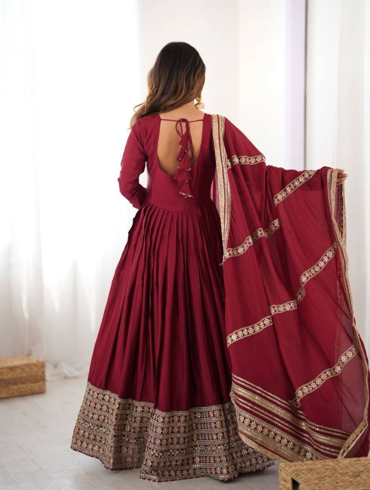 Red traditional outfit with gold details on a white background