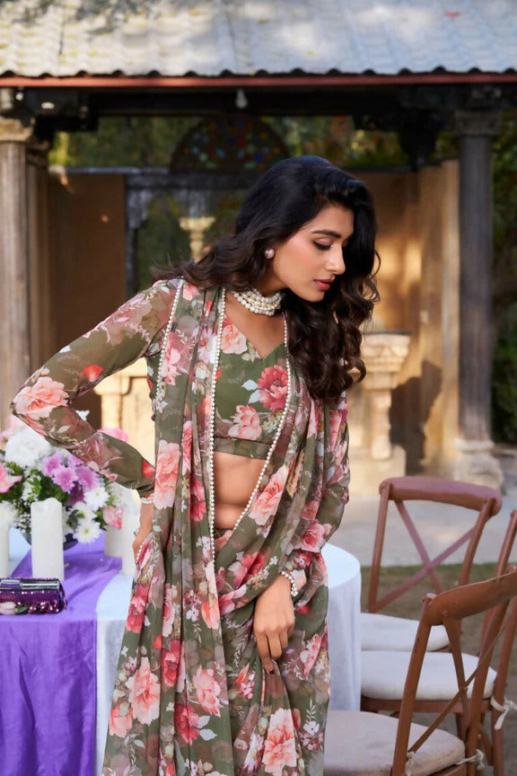 Woman in a floral dress standing outdoors with a decorative background