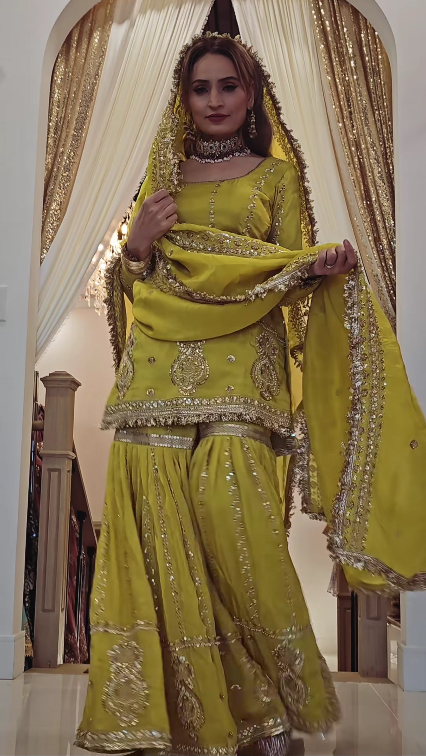 Perfect for festive occasions, this elegant yellow sharara suit features heavy golden embroidery.