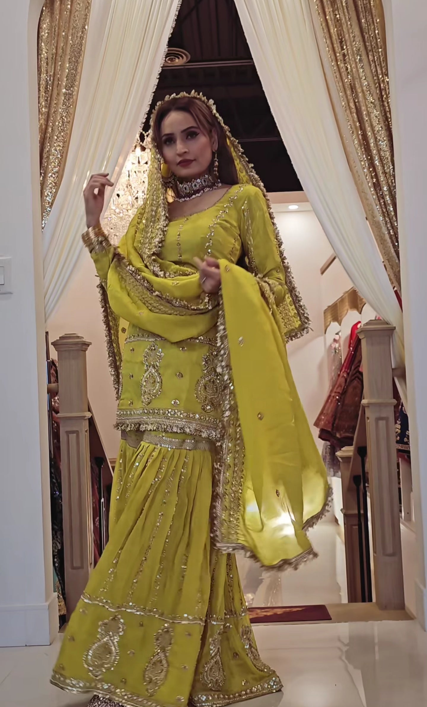 Perfect for festive occasions, this elegant yellow sharara suit features heavy golden embroidery.