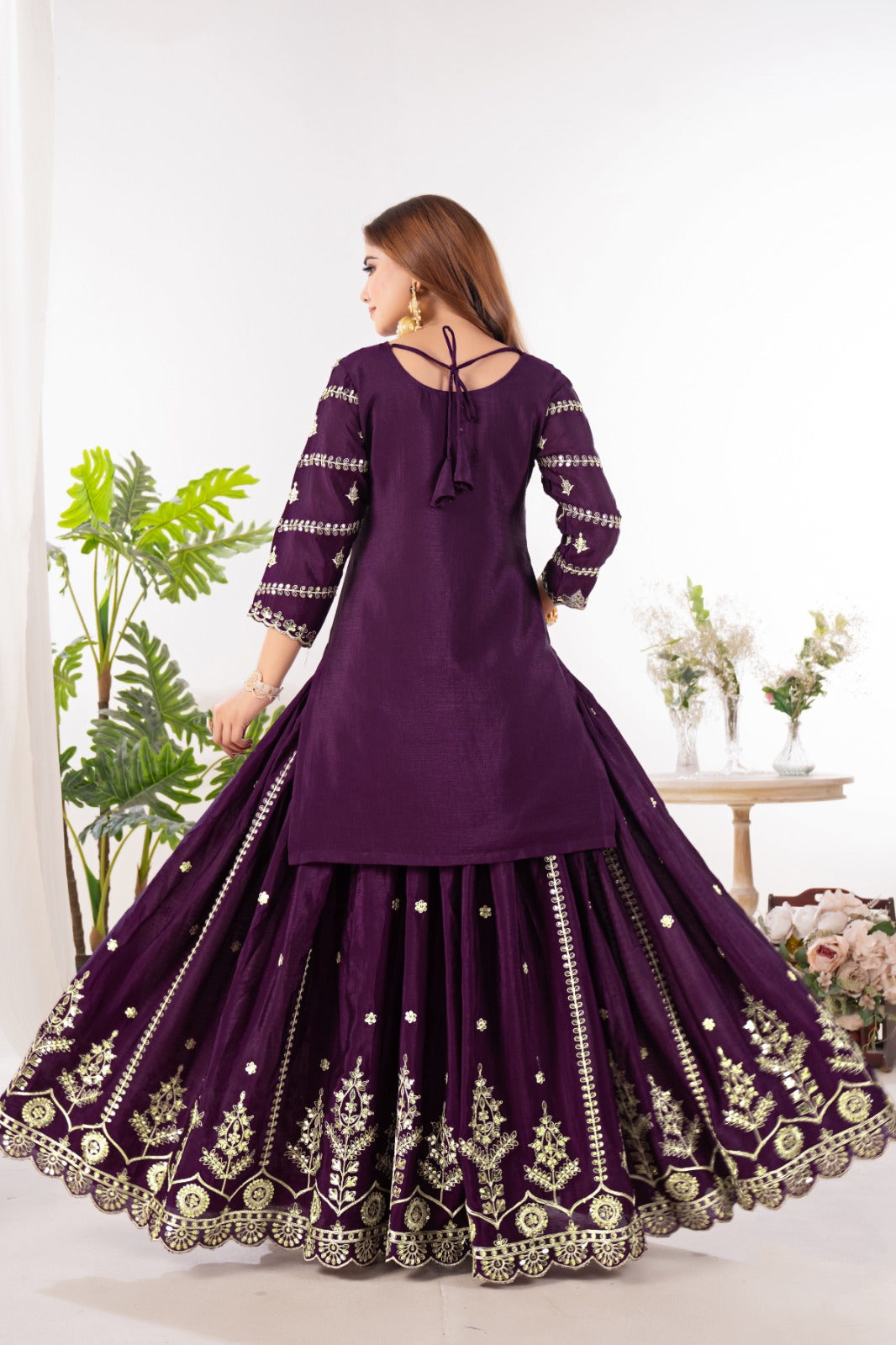 Embrace sophistication in this exquisite purple lehenga sharara suit, which combines classic design elements with modern flair.